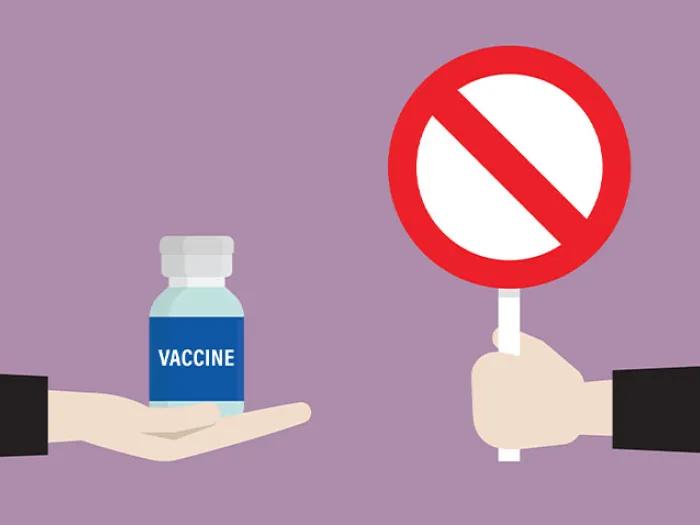 Hand holding stop symbol and a hand holding vaccine pill bottle.
