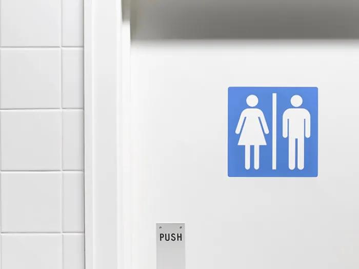 white bathroom door with blue gender sign