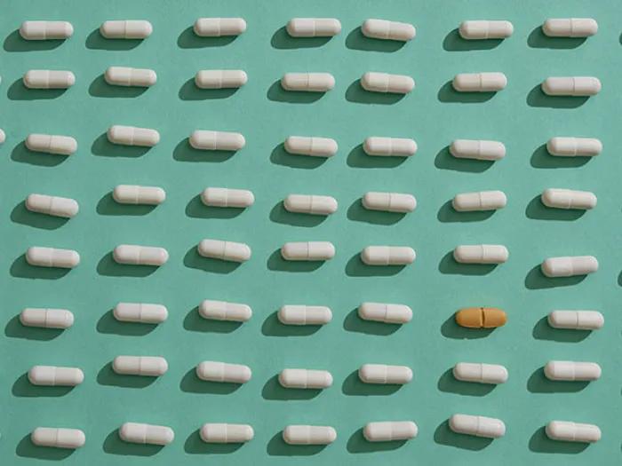 white brown pills on green background