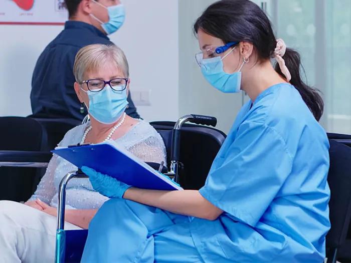 woman sitting with clinician in waiting room