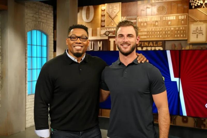 Smiling portrait of Joshua Perry and Jake Butt standing with their arms over each others' shoulders.