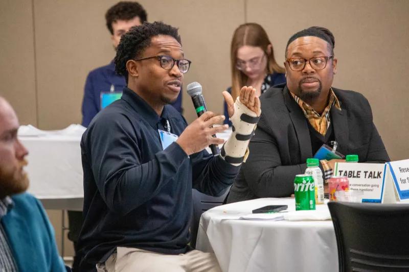A speaker at the 2025 Connection Session speaks into a microphone.