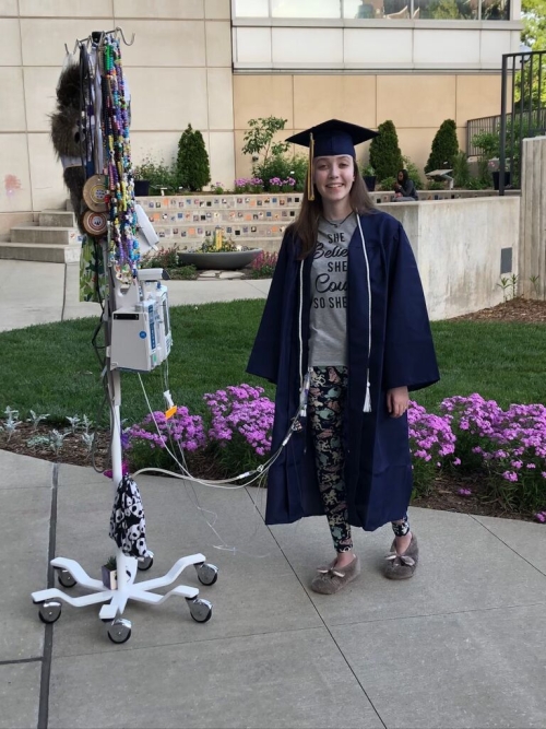 Elizabeth wearing graduation cap and gown.