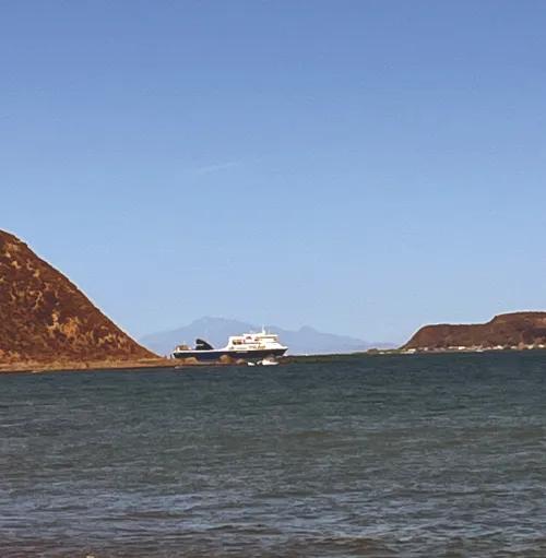 Photo of a yacht on the water in the distance. 