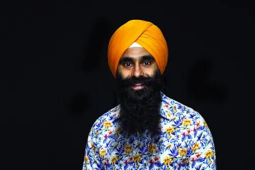 Headshot of Angad Singh. He's wearing an orange head covering and a floral shirt. 