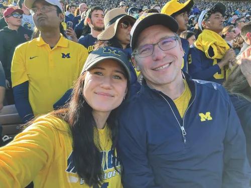Selfie of two people at a Michigan football game. 