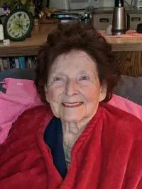 Older woman smiling at the camera. 