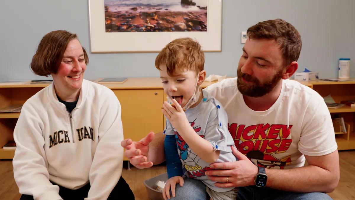  Child life specialist plays with little boy who is a patient at the hospital 