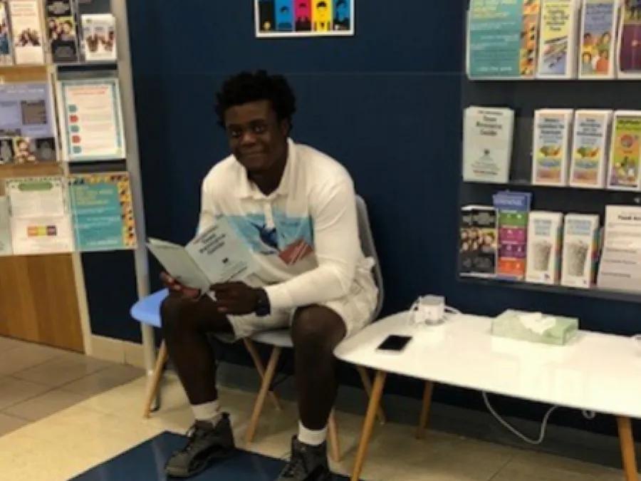 Young person sitting in a waiting room