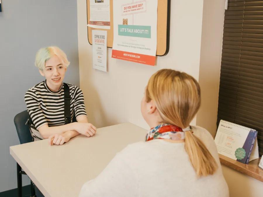 Teen girl speaks with provider