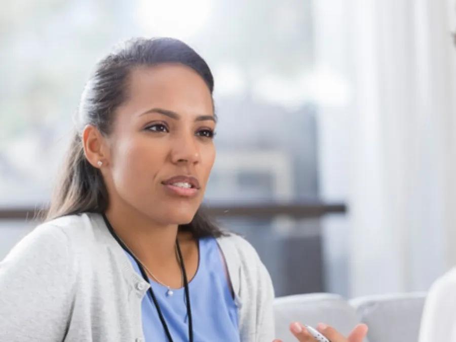 female staffer speaks with another staffer