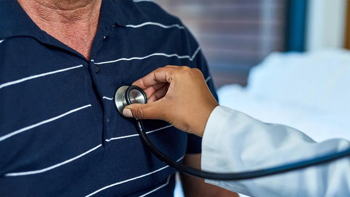 A doctor listening to a patient's heart
