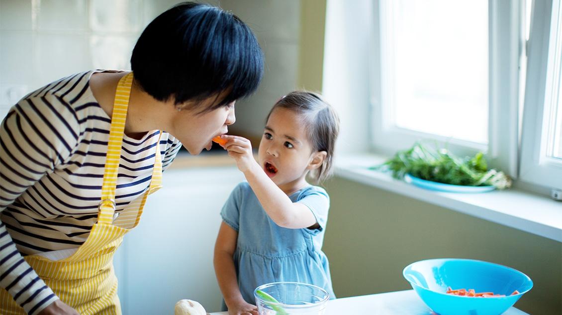 Child feeding parent healthy food