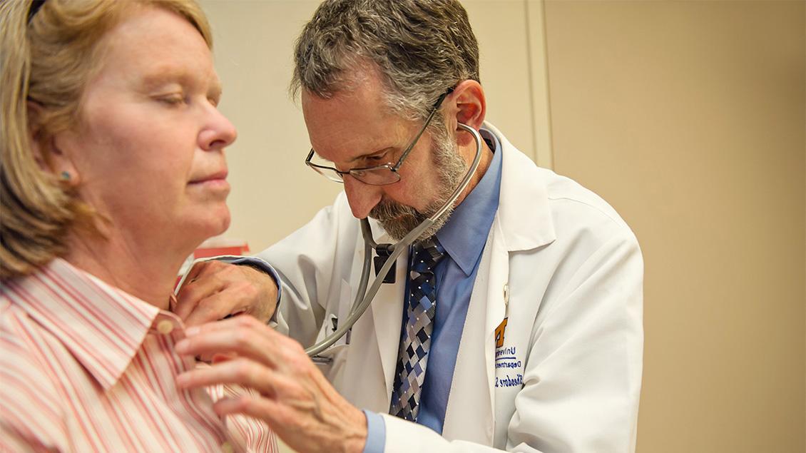 Doctor checking patient's neck area