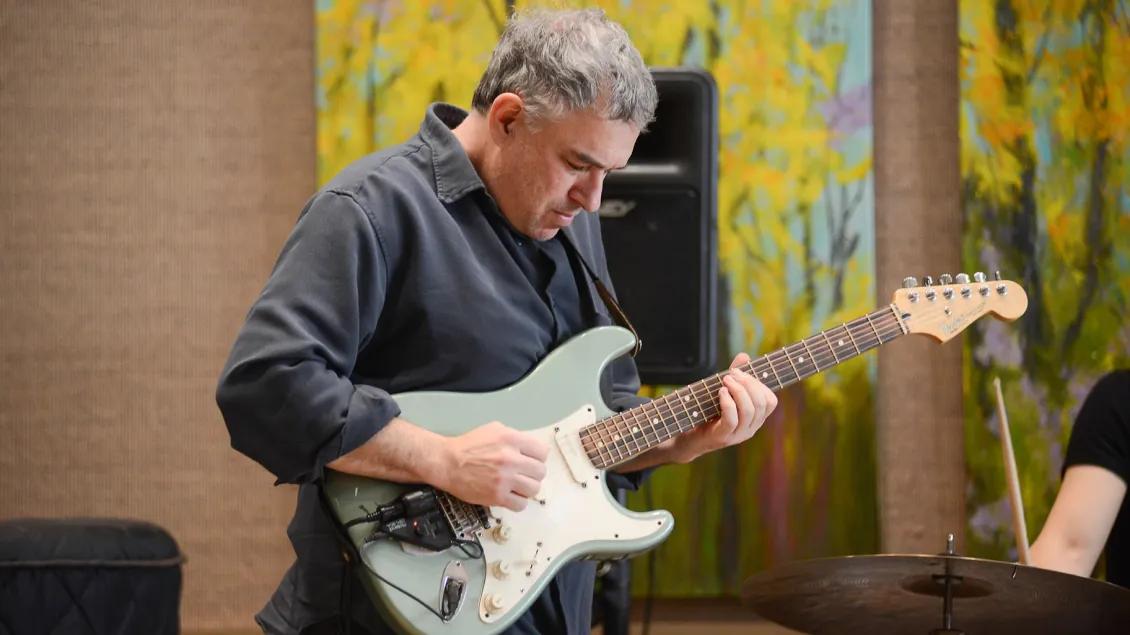 An electric guitar player performs as part of Gifts of Art