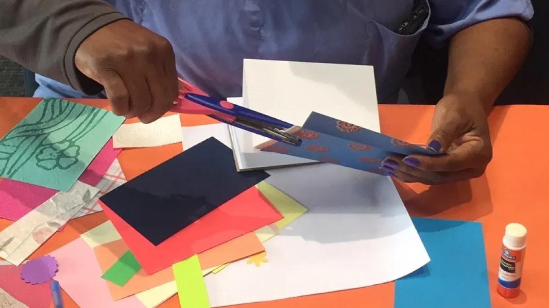 A volunteer works on paper crafts