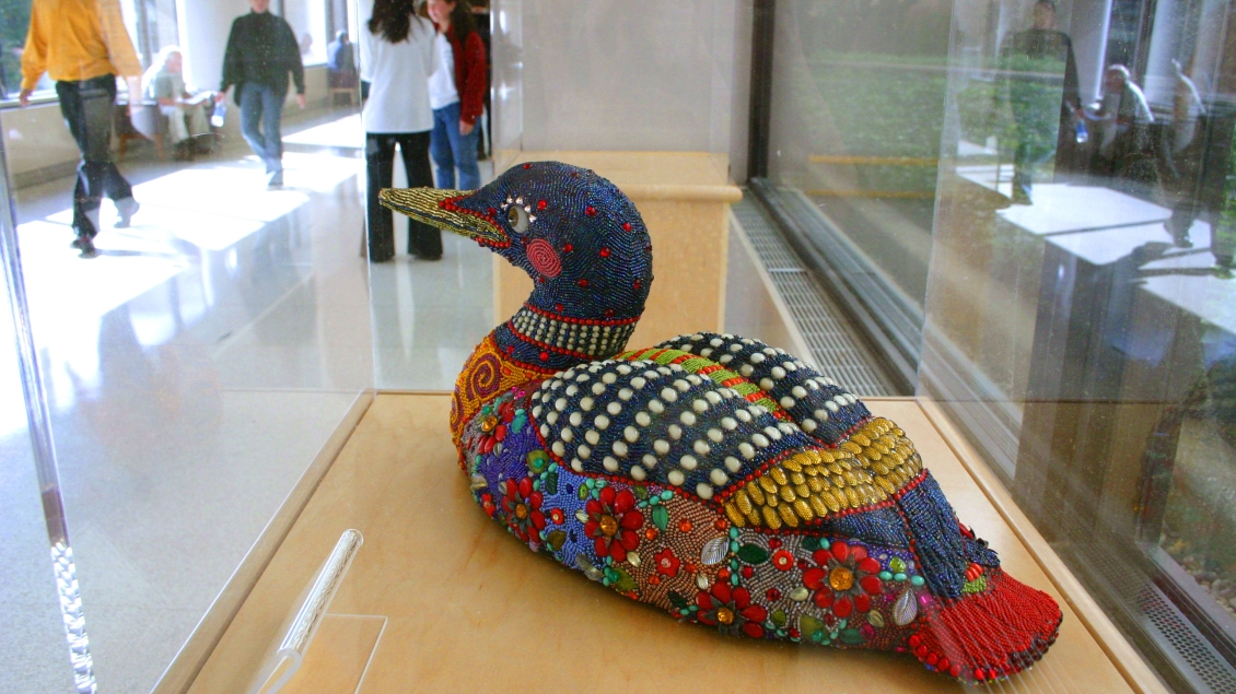 A loon sculpture covered in colorful beads