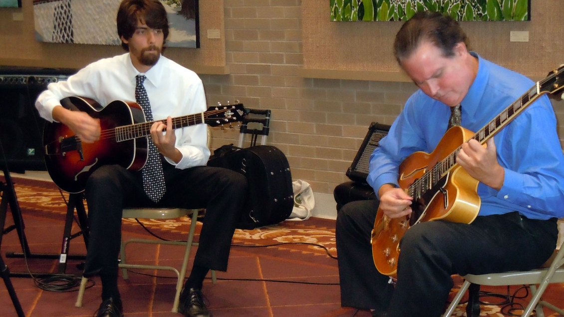 Two guitarists perform for Gifts of Art