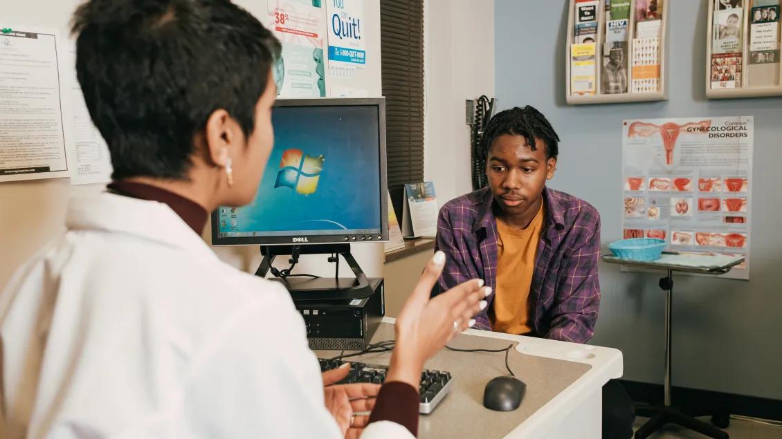 Dr. Nash speaks with a young patient