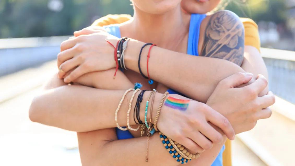 Woman has arms around another young woman