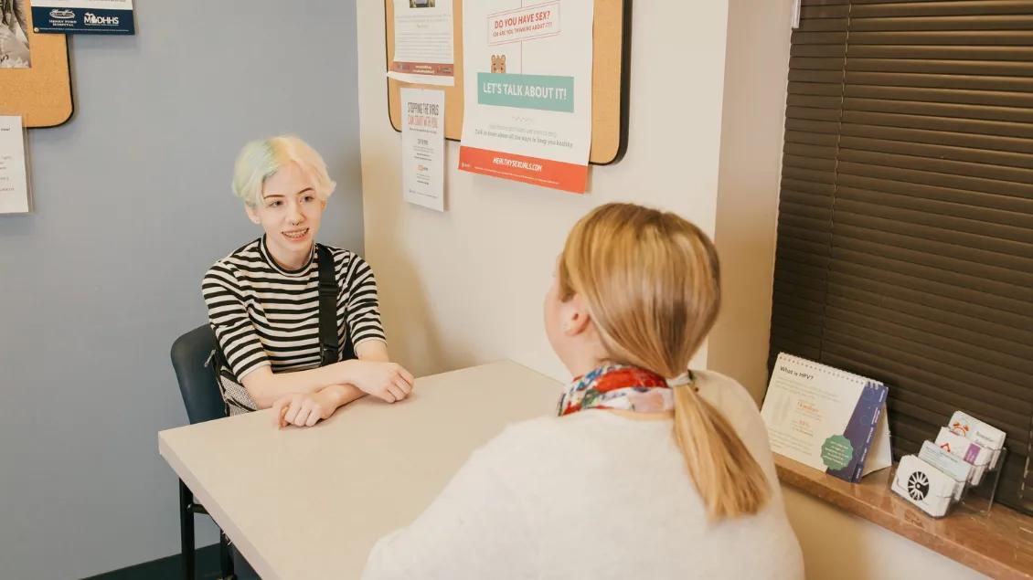 Teen girl speaks with provider