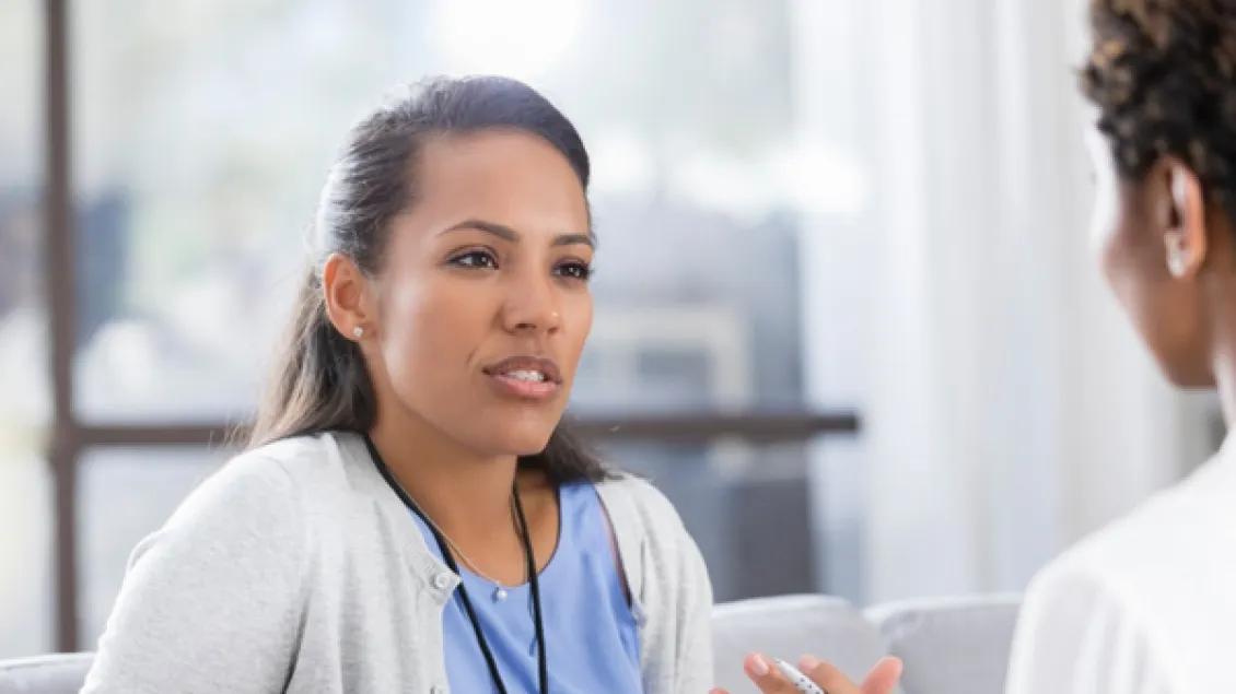 female staffer speaks with another staffer