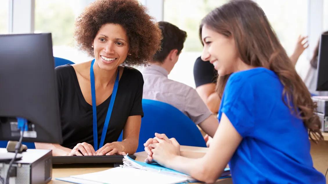 Women smiling and looking at the computer.