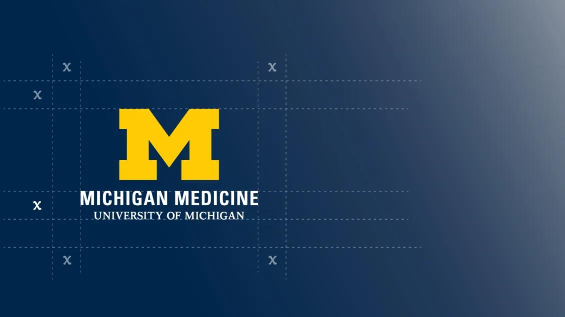 Maize block M with Michigan Medicine, University of Michigan on a blue background with x's in a grid