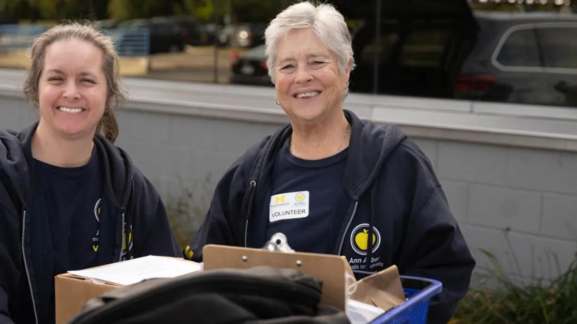 Two women deliver groceries for Ann Arbor Meals on Wheels