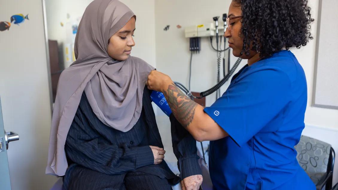 Provider examining a patient in an exam room