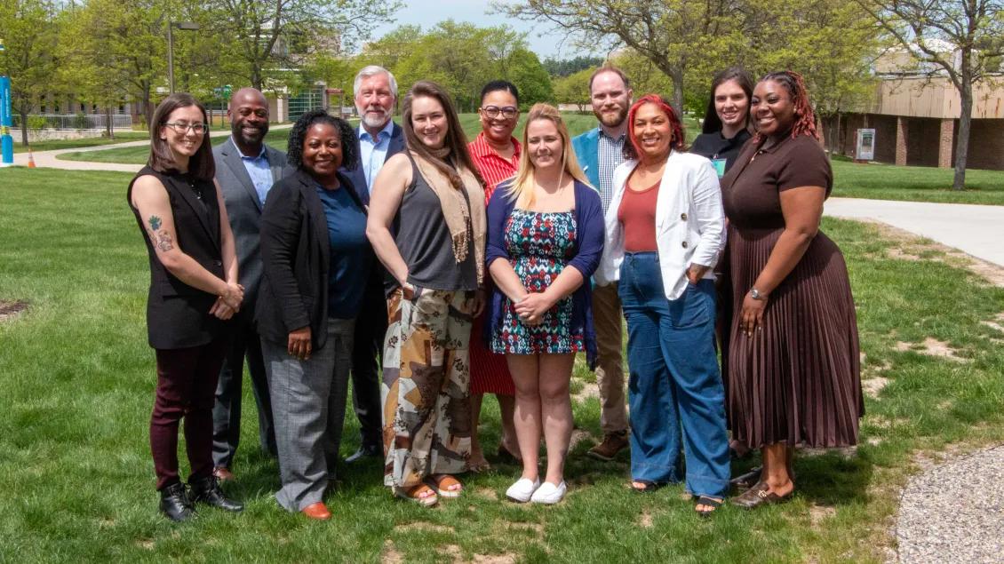 A picture of the AHI team standing outside on a spring day.