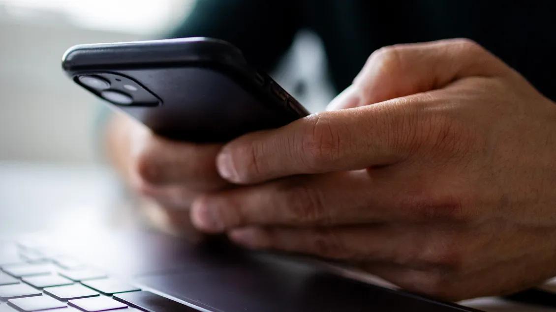 Close up on man hand using mobile phone
