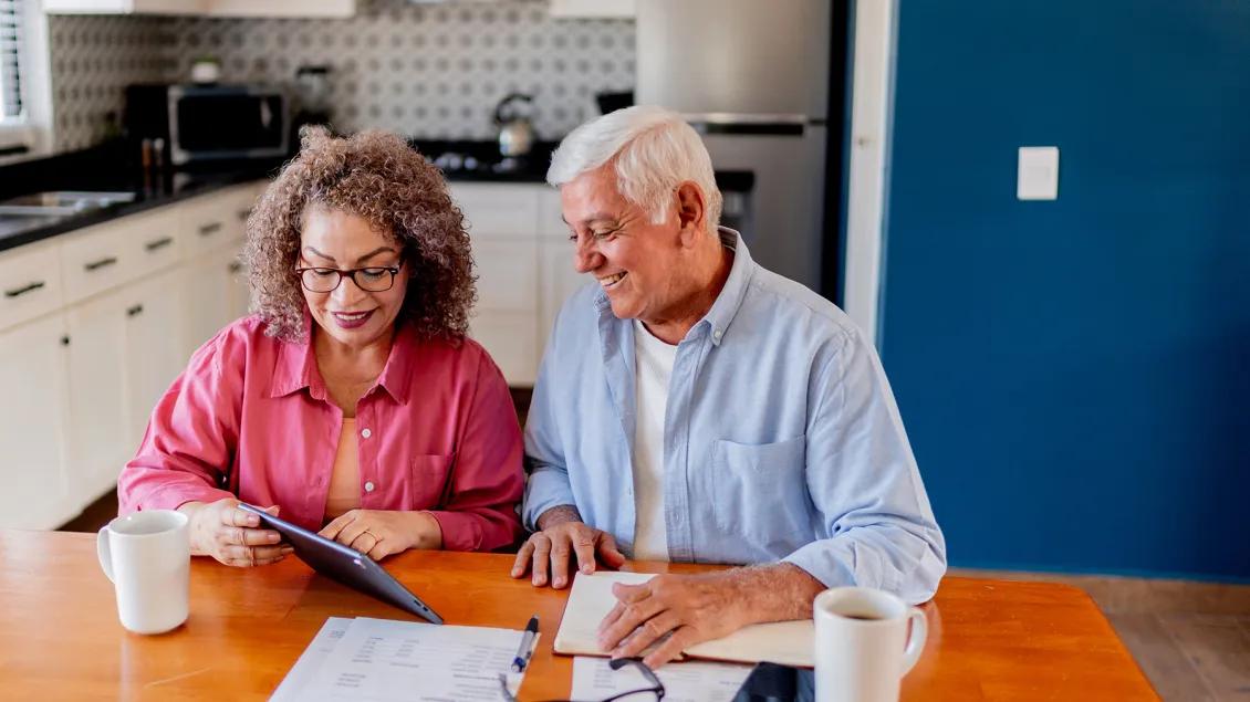Senior couple talking and doing home finance