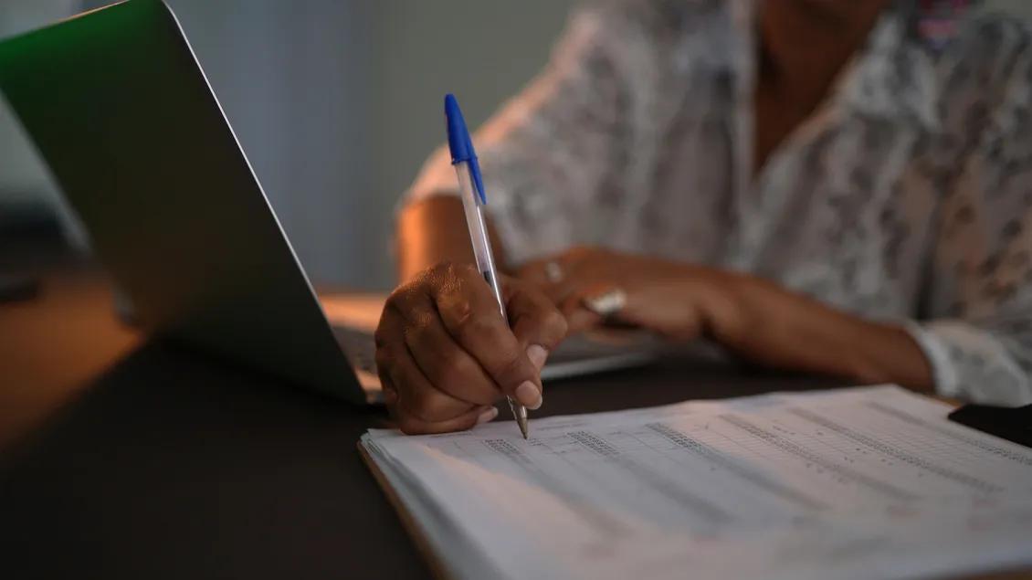 Senior woman using laptop control spreadsheet