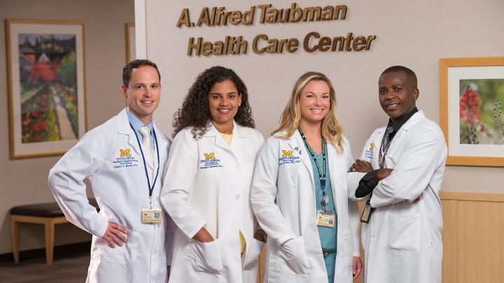 Four PAs in white coats at the Taubman Health Center