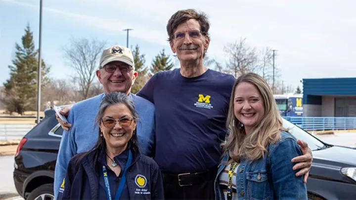 Two men and two women stand together