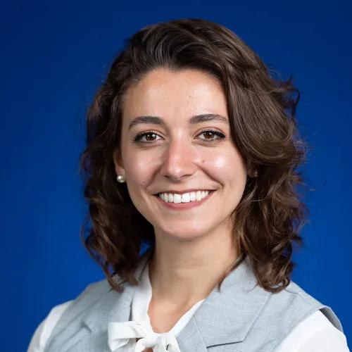 Headshot of Kelly Bertoni. She is wearing a light blue vest and a white blouse.