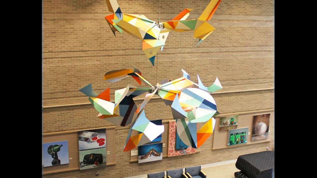 Colorful birds sculpture hanging from a ceiling