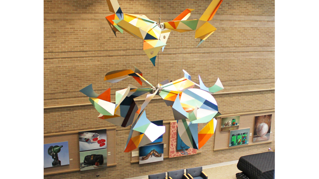 Colorful birds sculpture hanging from a ceiling