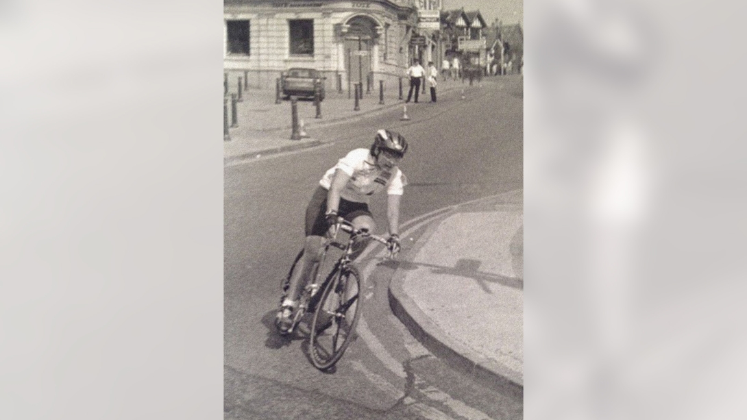 woman on bike competing and turning corner black and white photo shorts biking