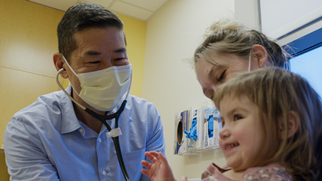 doctor with mask on with patient and mom close up