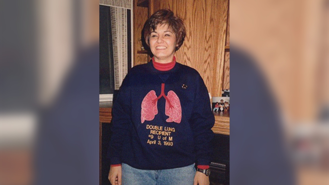 sweater with lungs on it woman standing in kitchen