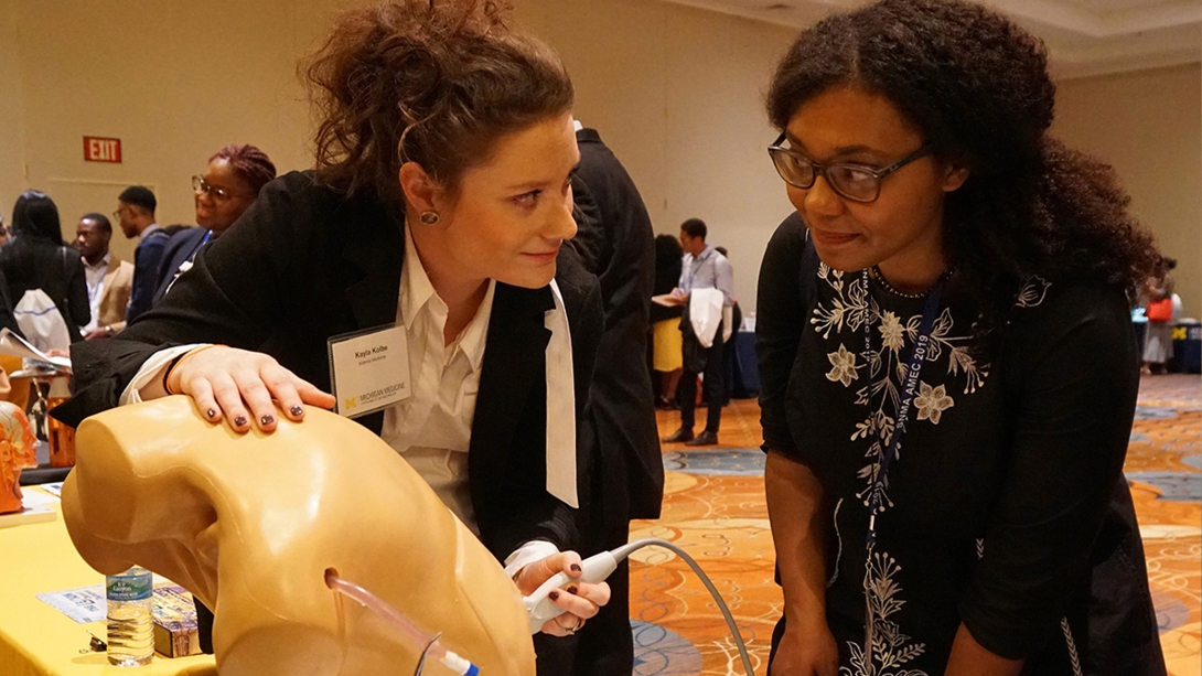 measuring breathing ultrasound dummy vitals two people at conference closer up