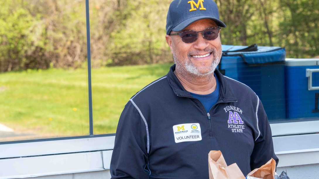 Ann Arbor Meals on Wheels volunteer carrying grocery bag