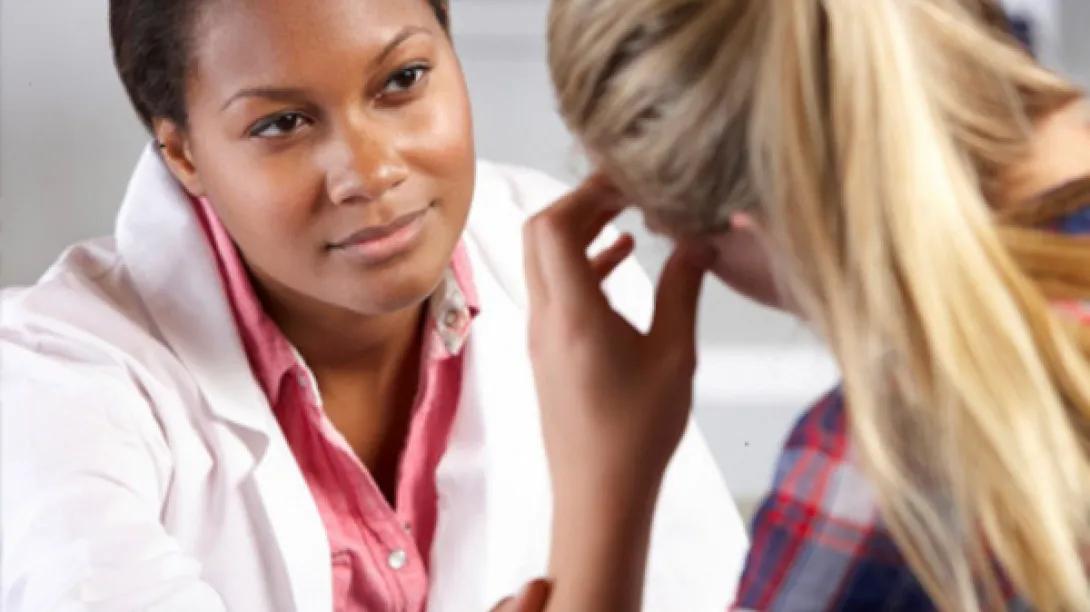 A doctor looking at a worried patient.