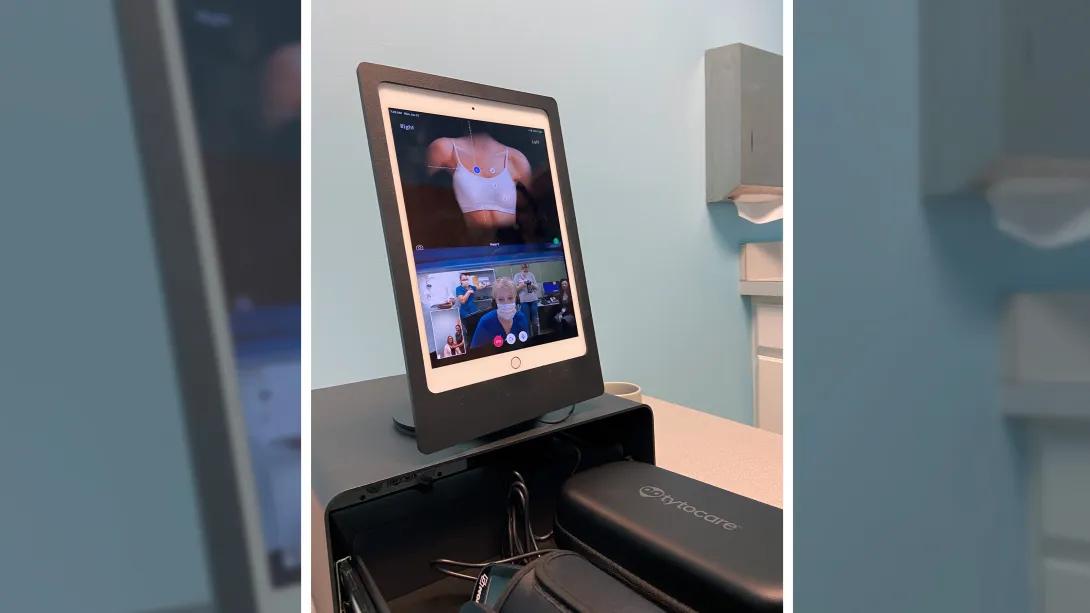 Telehealth visit shown on computer screen.