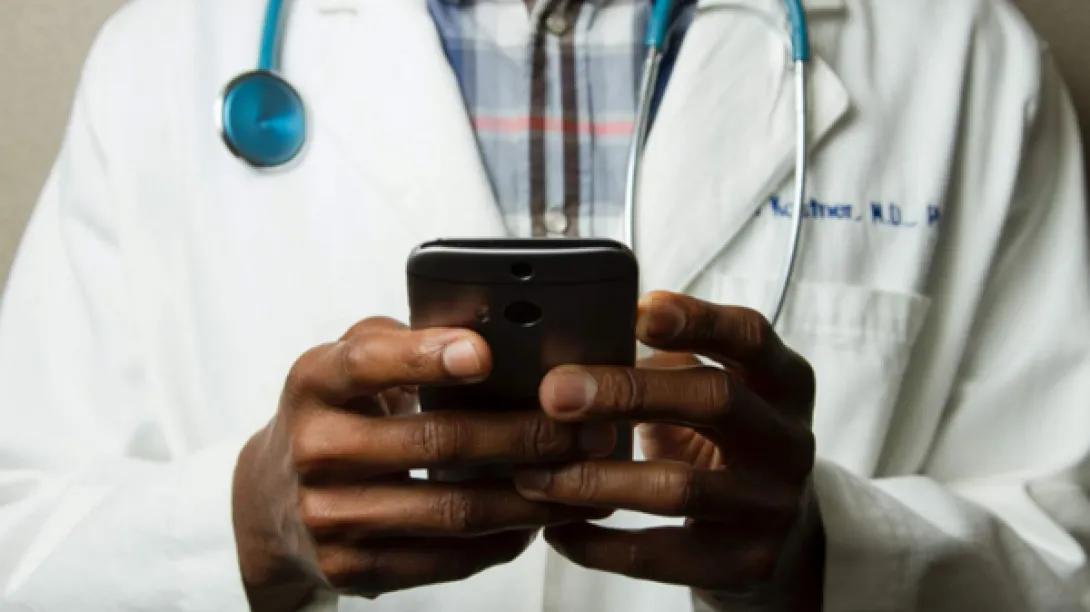 Doctor holding his phone.