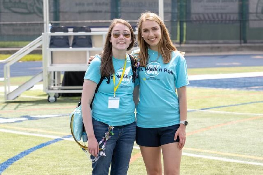 Elizabeth and Claire smiling wearing RWR5K blue t-shirts. 