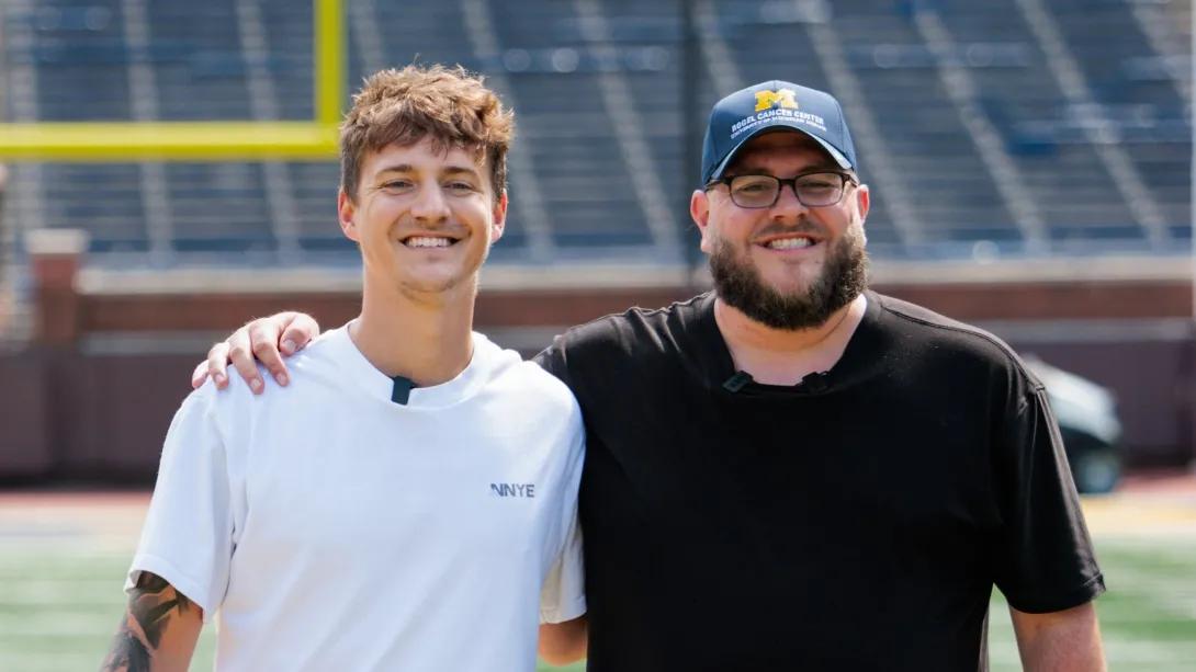 Ninja and BeardedBlevins stand on the field at Michigan Stadium.