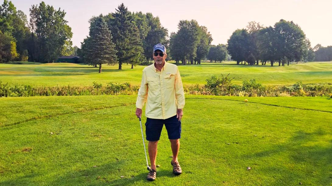man standing on golf course
